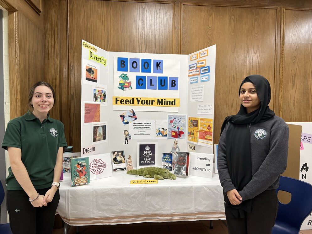Picture of two students in front of a booth