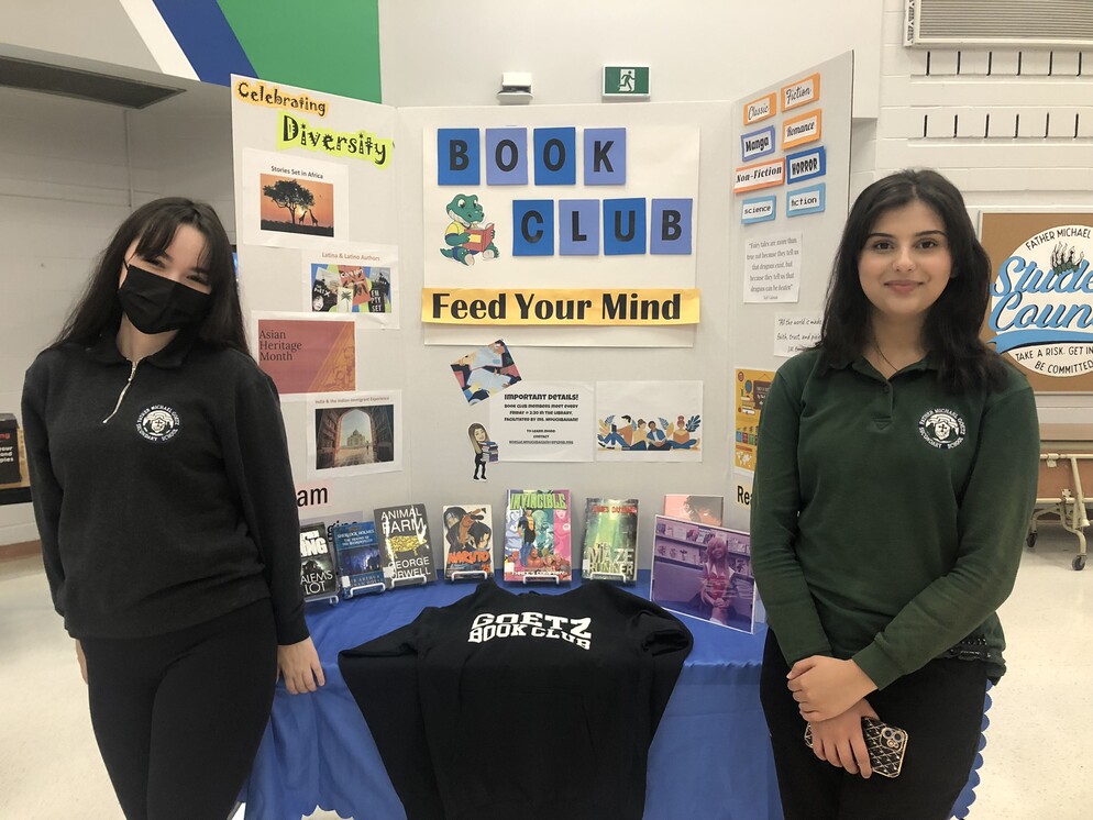 Picture of two students in front of a booth